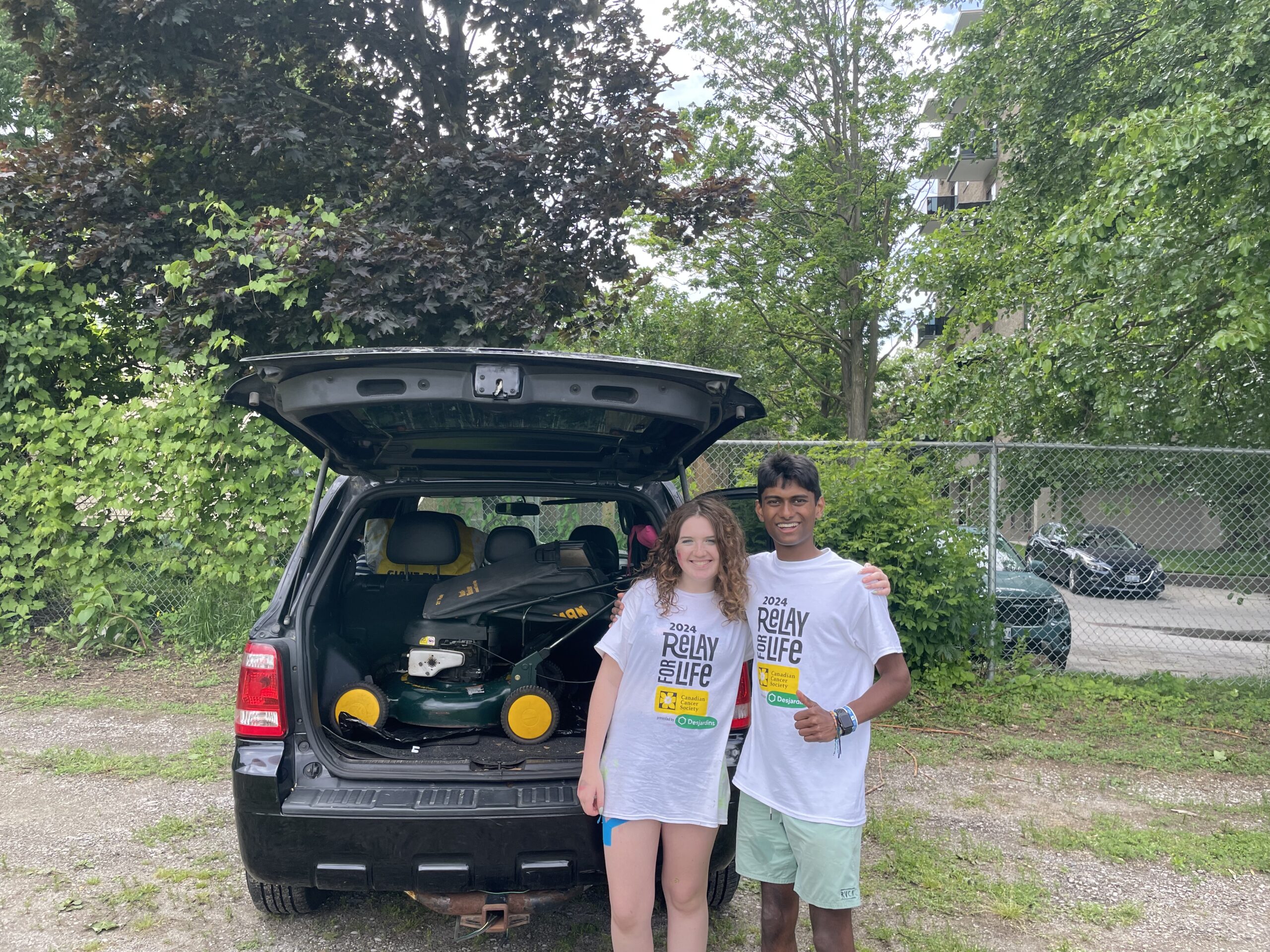 Allan donating a lawnmower though his company for realy for life